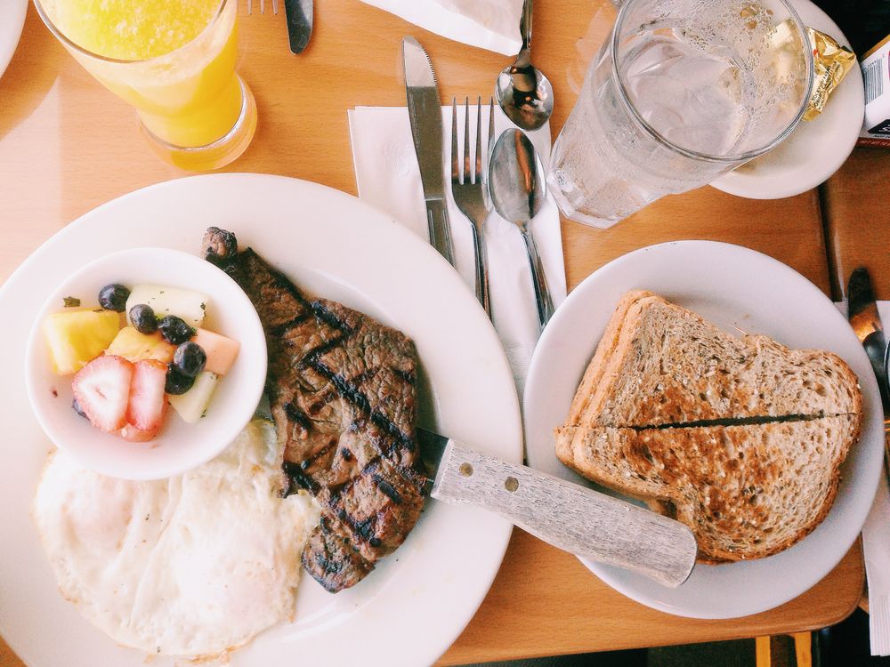 Plate with grilled steak, eggs, and toast, a high protein meal
