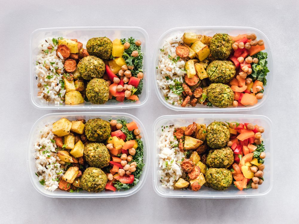 Colorful meal prep containers with balanced macros including protein, carbs, and vegetables